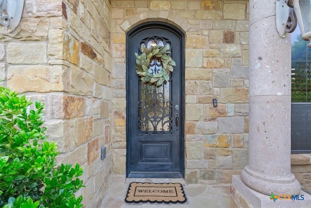 entrance to property with stone siding