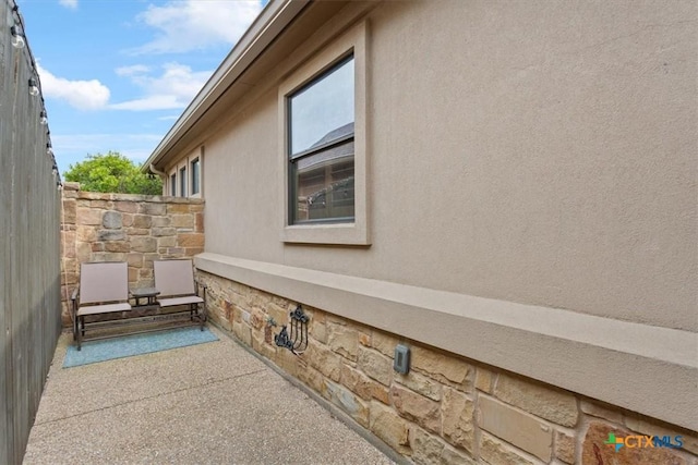 view of property exterior with stone siding and crawl space