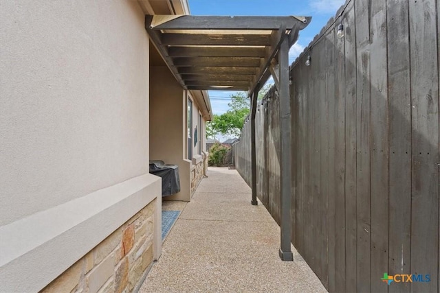 view of property exterior featuring stucco siding and fence