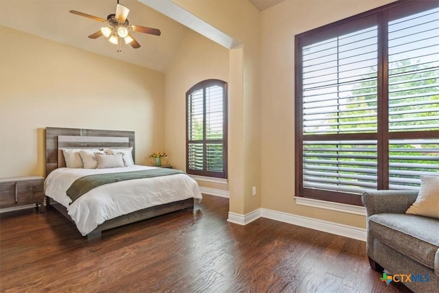 bedroom featuring wood finished floors, baseboards, vaulted ceiling, and ceiling fan
