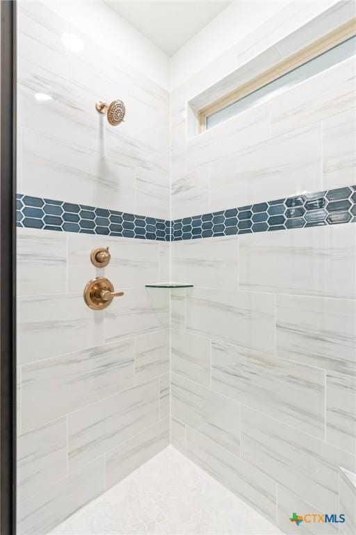 bathroom with a tile shower