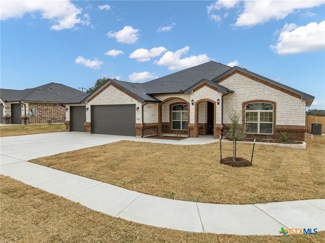 view of front of house with a garage and a front yard