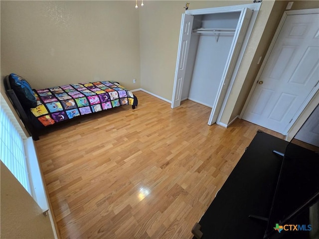 bedroom featuring light hardwood / wood-style flooring and a closet