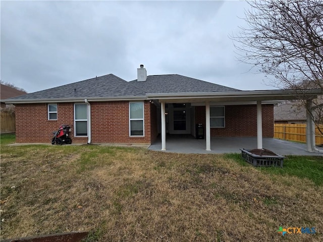 rear view of property with a yard and a patio area