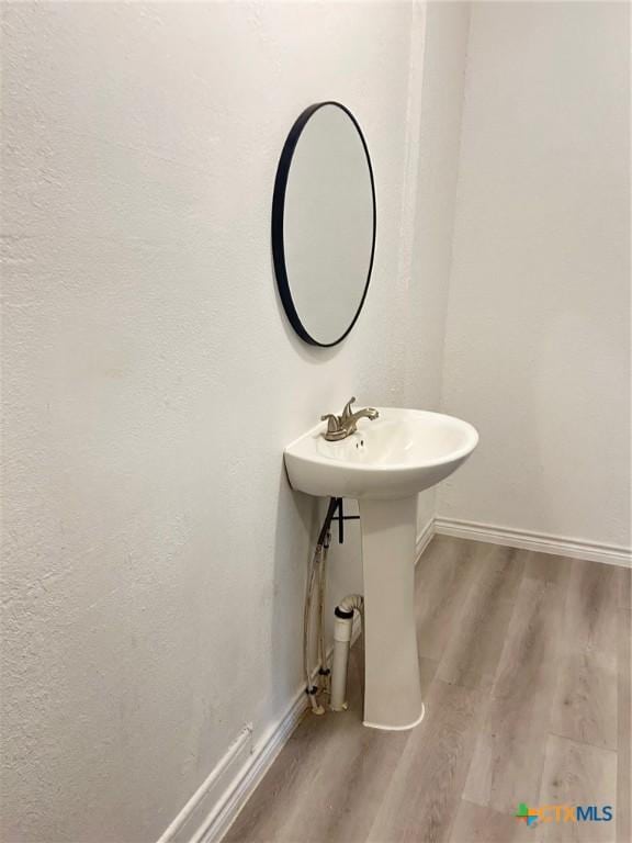 1108 S 47th St, Temple, TX 76504 - bathroom with wood finished floors and baseboards