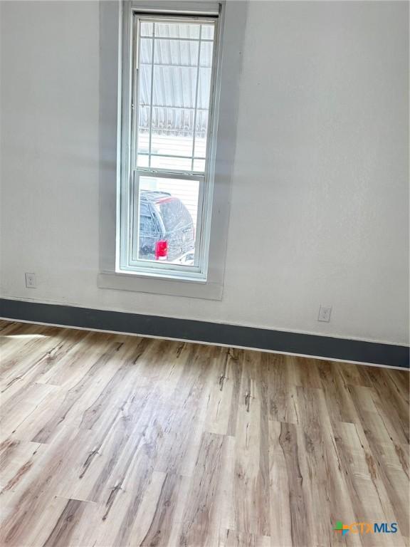 1108 S 47th St, Temple, TX 76504 - unfurnished room with wood finished floors and baseboards
