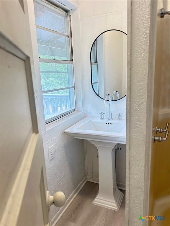 1108 S 47th St, Temple, TX 76504 - bathroom with wood finished floors and baseboards