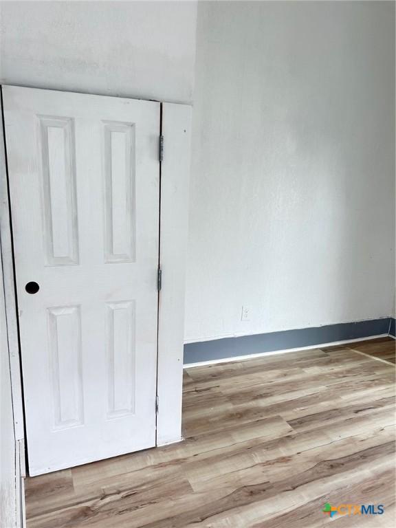 1108 S 47th St, Temple, TX 76504 - empty room with light wood-style flooring and baseboards