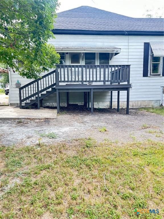 1108 S 47th St, Temple, TX 76504 - back of house featuring a shingled roof, a deck, and stairway