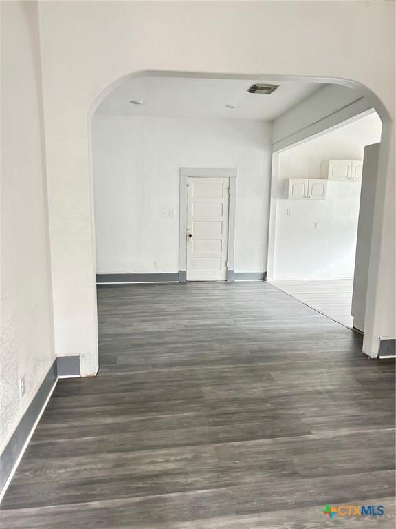 1108 S 47th St, Temple, TX 76504 - unfurnished room featuring arched walkways and dark wood-style floors