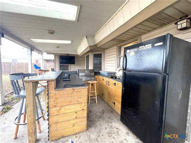 interior space with a grill and an outdoor wet bar