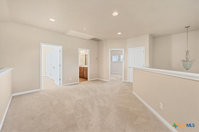 spare room with lofted ceiling and light carpet