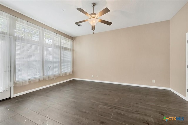 unfurnished room with ceiling fan, dark hardwood / wood-style flooring, and plenty of natural light