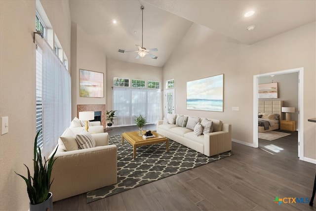 living room with ceiling fan, dark hardwood / wood-style flooring, and high vaulted ceiling