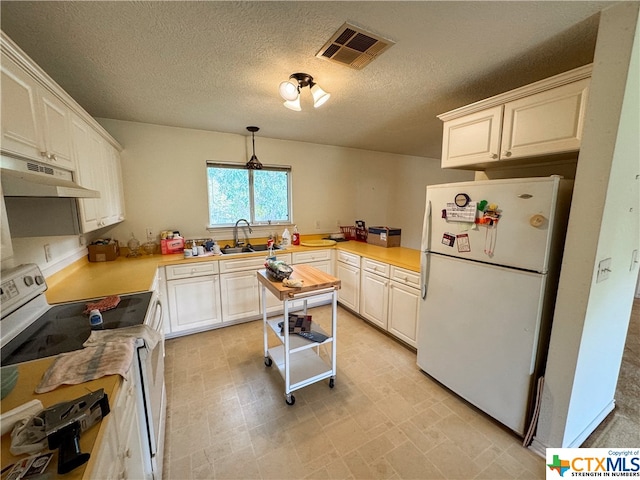 kitchen featuring a textured ceiling, pendant lighting, sink, white cabinets, and white appliances