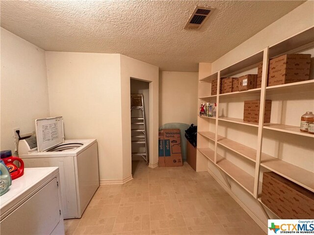 21 Anderson Ln, Coldspring, TX 77331 - washroom featuring washing machine and dryer and a textured ceiling