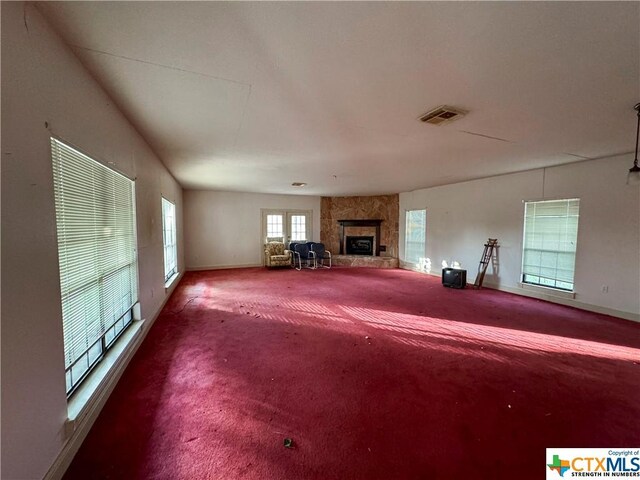 21 Anderson Ln, Coldspring, TX 77331 - living room featuring carpet floors, baseboards, and a fireplace