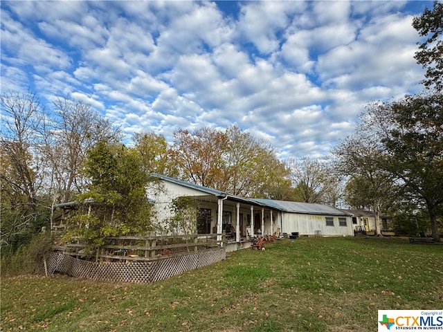 back of house featuring a yard and a deck