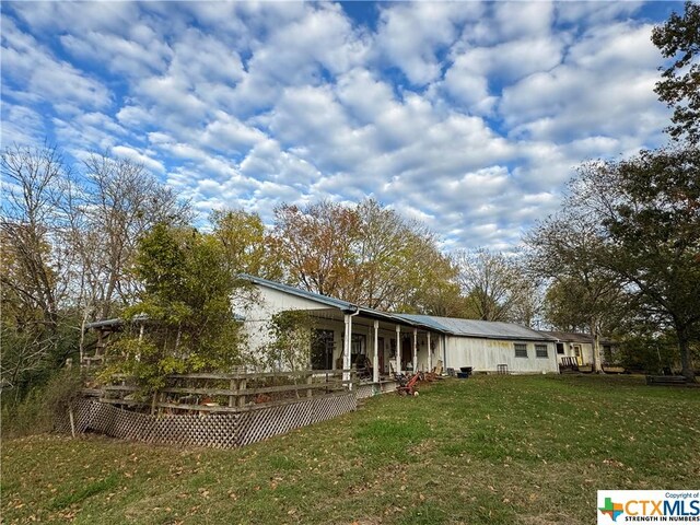 21 Anderson Ln, Coldspring, TX 77331 - rear view of property with a yard and a wooden deck