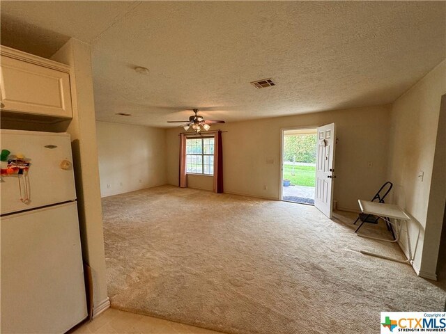 21 Anderson Ln, Coldspring, TX 77331 - unfurnished room featuring light colored carpet, a ceiling fan, and a textured ceiling