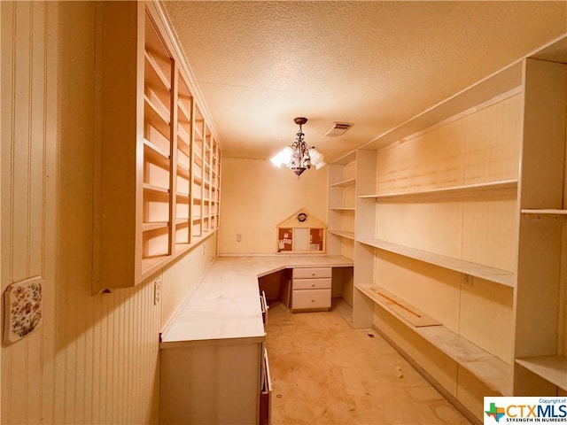 21 Anderson Ln, Coldspring, TX 77331 - unfurnished office with a chandelier, a textured ceiling, light colored carpet, and built in desk