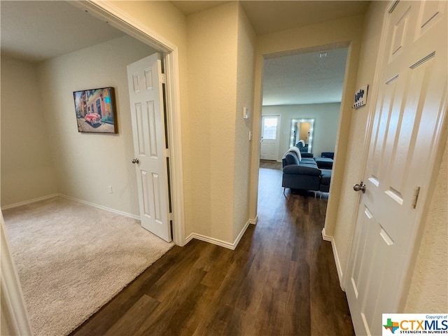 hall with dark wood-type flooring