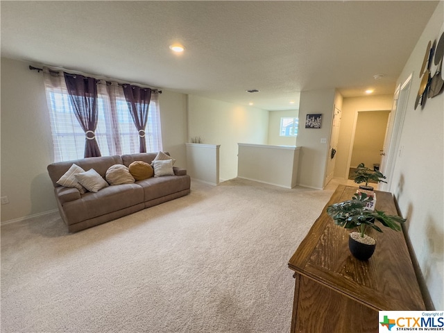 carpeted living room with a textured ceiling