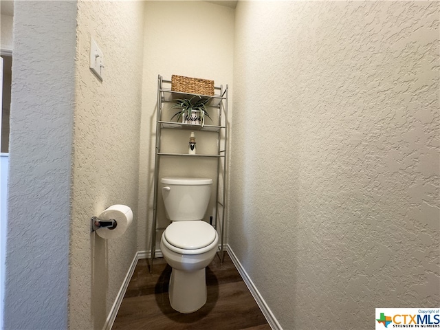 bathroom with hardwood / wood-style floors and toilet