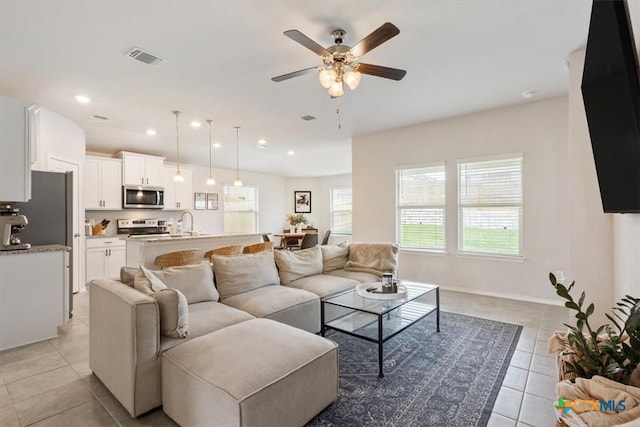 2407 Freddie L Nichols Sr Dr, Harker Heights, TX 76548 - living area featuring light tile patterned flooring, a ceiling fan, and recessed lighting