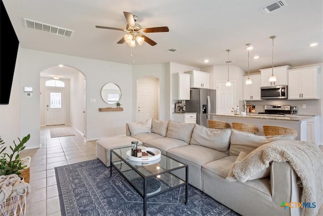 2407 Freddie L Nichols Sr Dr, Harker Heights, TX 76548 - living area with arched walkways, a ceiling fan, light tile patterned flooring, and recessed lighting