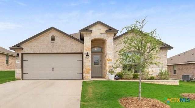 2407 Freddie L Nichols Sr Dr, Harker Heights, TX 76548 - french country home featuring stone siding, a garage, driveway, and a front yard