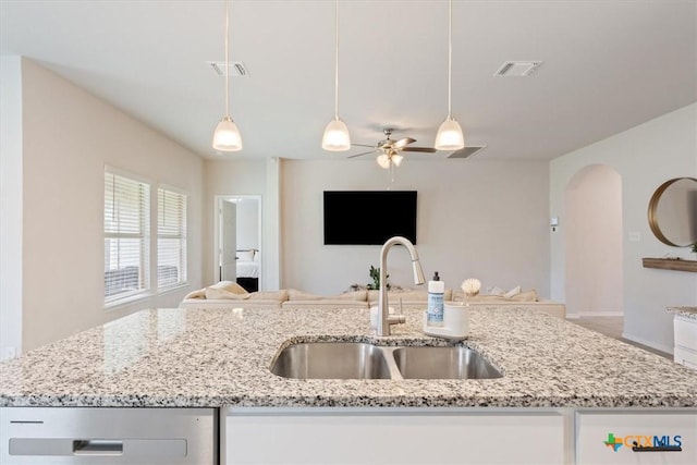 2407 Freddie L Nichols Sr Dr, Harker Heights, TX 76548 - kitchen featuring open floor plan, stainless steel dishwasher, a ceiling fan, arched walkways, and hanging light fixtures
