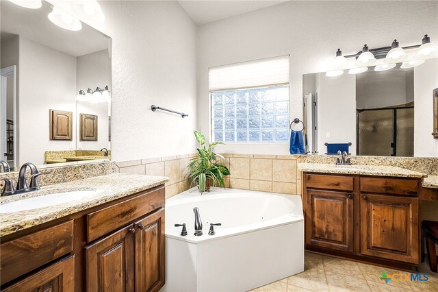 19530 Creekview Oaks, San Antonio, TX 78266 - full bathroom featuring a stall shower, two vanities, a garden tub, and tile patterned floors