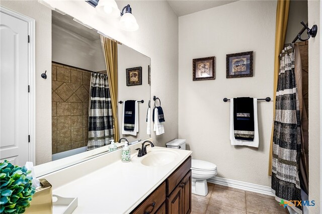 19530 Creekview Oaks, San Antonio, TX 78266 - bathroom featuring double vanity, a shower with shower curtain, and tile patterned floors