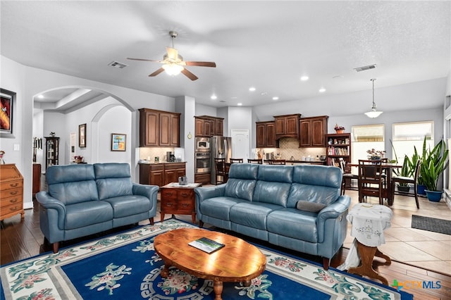 living room featuring light wood-type flooring and ceiling fan