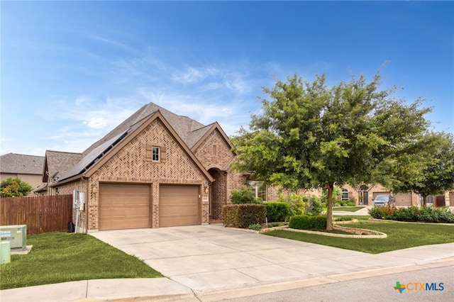 view of front of home featuring a garage and a front lawn