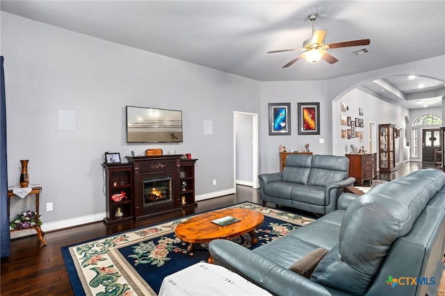 living room featuring dark hardwood / wood-style flooring and ceiling fan