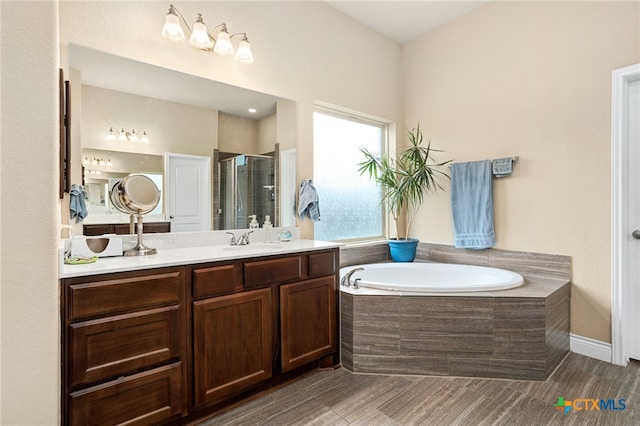 bathroom with vanity and separate shower and tub