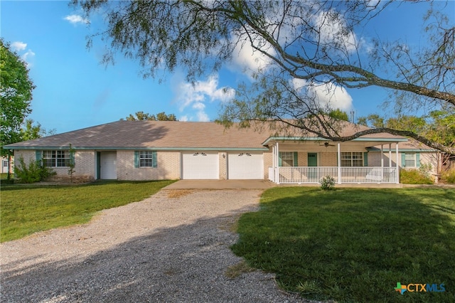 ranch-style house with a porch, a garage, and a front lawn