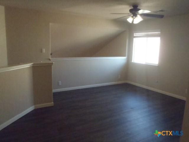 additional living space with ceiling fan and dark wood-type flooring