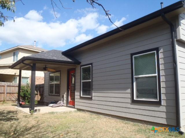 back of house with a yard, ceiling fan, and a patio