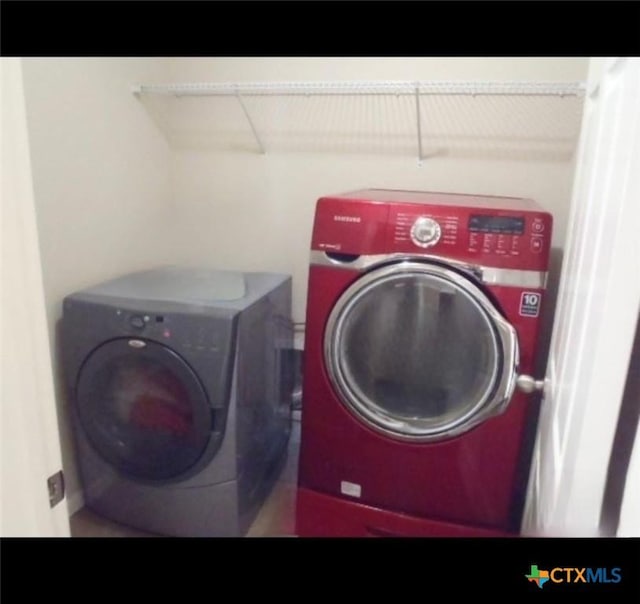 clothes washing area with washer and dryer