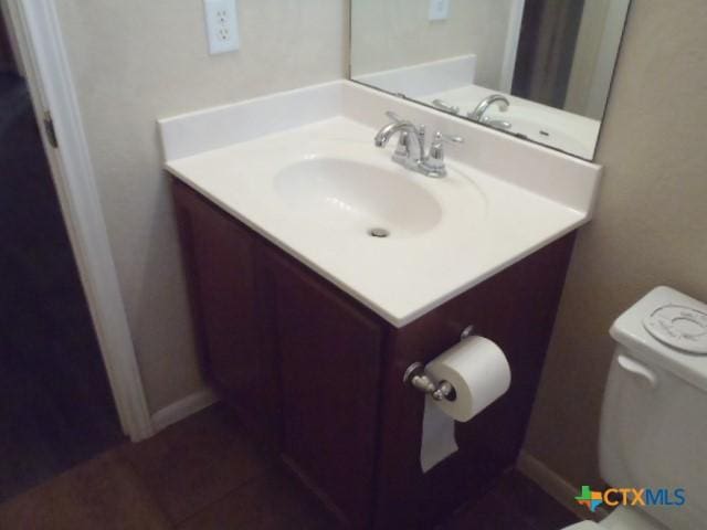 bathroom with toilet and vanity