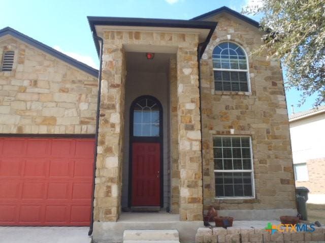 view of exterior entry featuring a garage