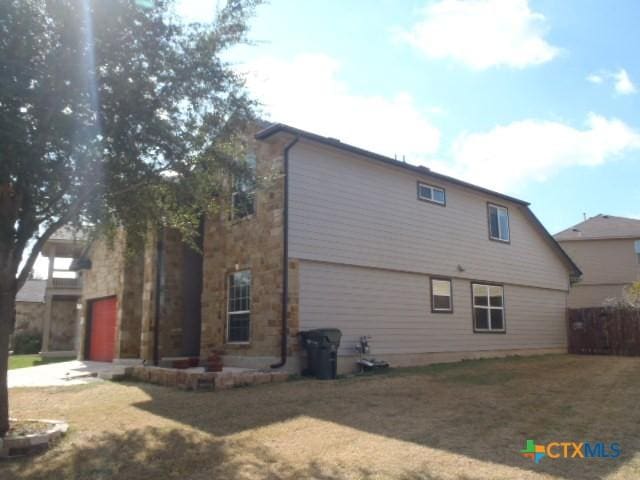 back of property featuring a lawn