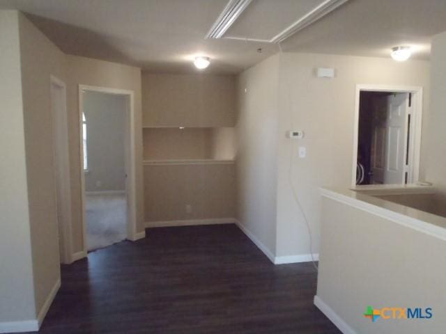 corridor with dark wood-type flooring