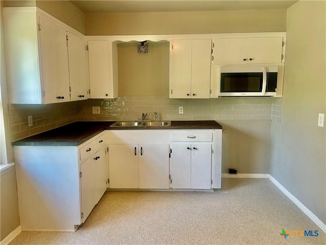413 Vickers Ave, Seguin, TX 78155 - kitchen with a sink, decorative backsplash, and baseboards