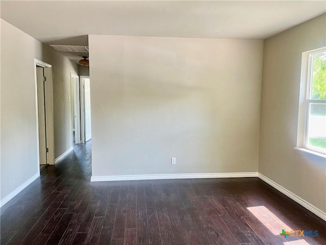 413 Vickers Ave, Seguin, TX 78155 - unfurnished room featuring dark wood-style floors, healthy amount of natural light, and baseboards