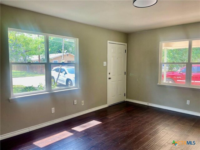 413 Vickers Ave, Seguin, TX 78155 - spare room with plenty of natural light, dark wood finished floors, and baseboards