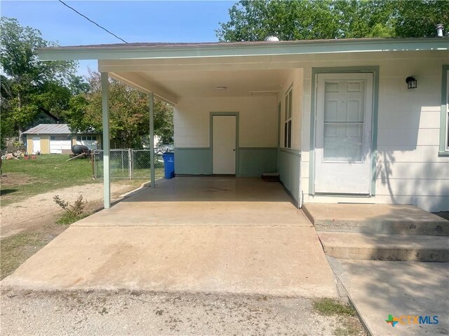413 Vickers Ave, Seguin, TX 78155 - property entrance with a carport, driveway, and fence